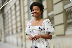 Person wearing a cottagecore outfit with white floral dress and puff sleeves