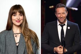 Dakota Johnson Gray Coat Soft Smile Chris Martin Suit on Stage Smiling