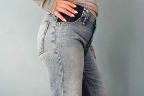 A pregnant person wearing the Hudson Rosie Maternity Wide Leg Ankle Jean