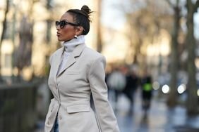 A woman wearing a turtleneck and blazer