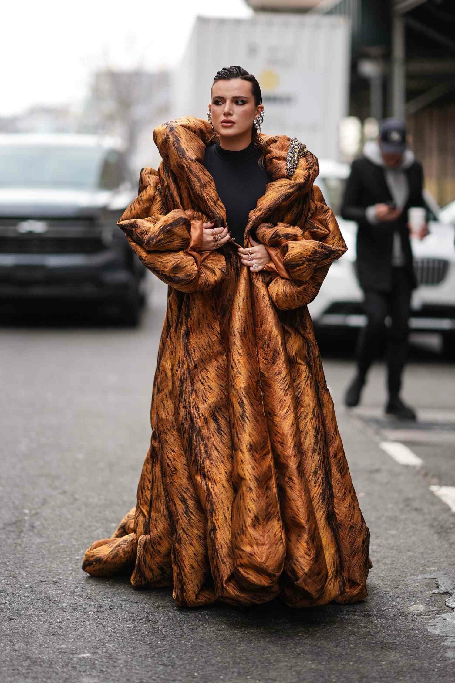 Bella Thorne wears a statement coat, one of the best NYFW FW24 street style looks.