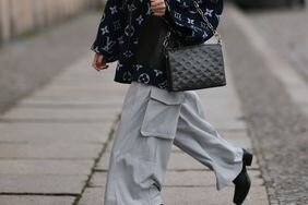 A woman wearing grey cargo pants and boots