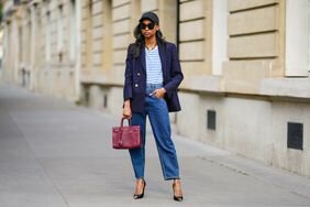 Woman wearing a striped top, blue blazer, and double-waisted jeans