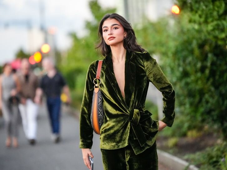 Person wearing a green velvet suit cocktail attire wedding dress code