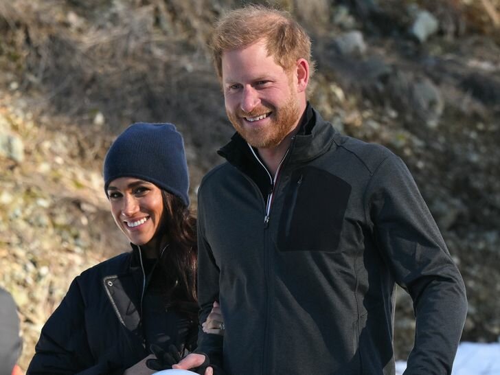 Meghan Markle Holding Prince Harry's Arm While Both Smiling and Walking Through the Snow at Invictus Event in Canada