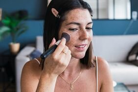 woman applying foundation