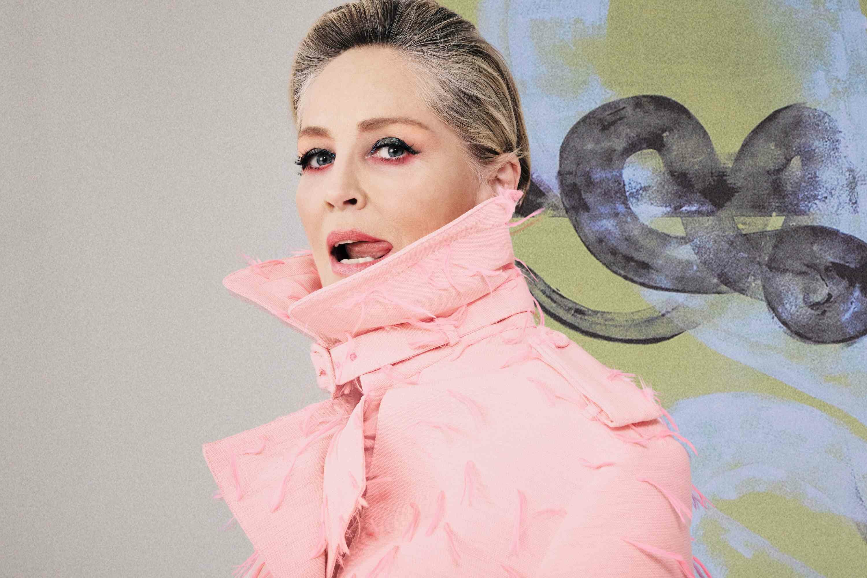 Sharon Stone Pink Roberto Cavalli coat sticking tongue out