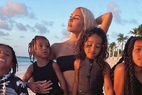 kim kardashian north, saint, chicago, and psalm west pose on the beach