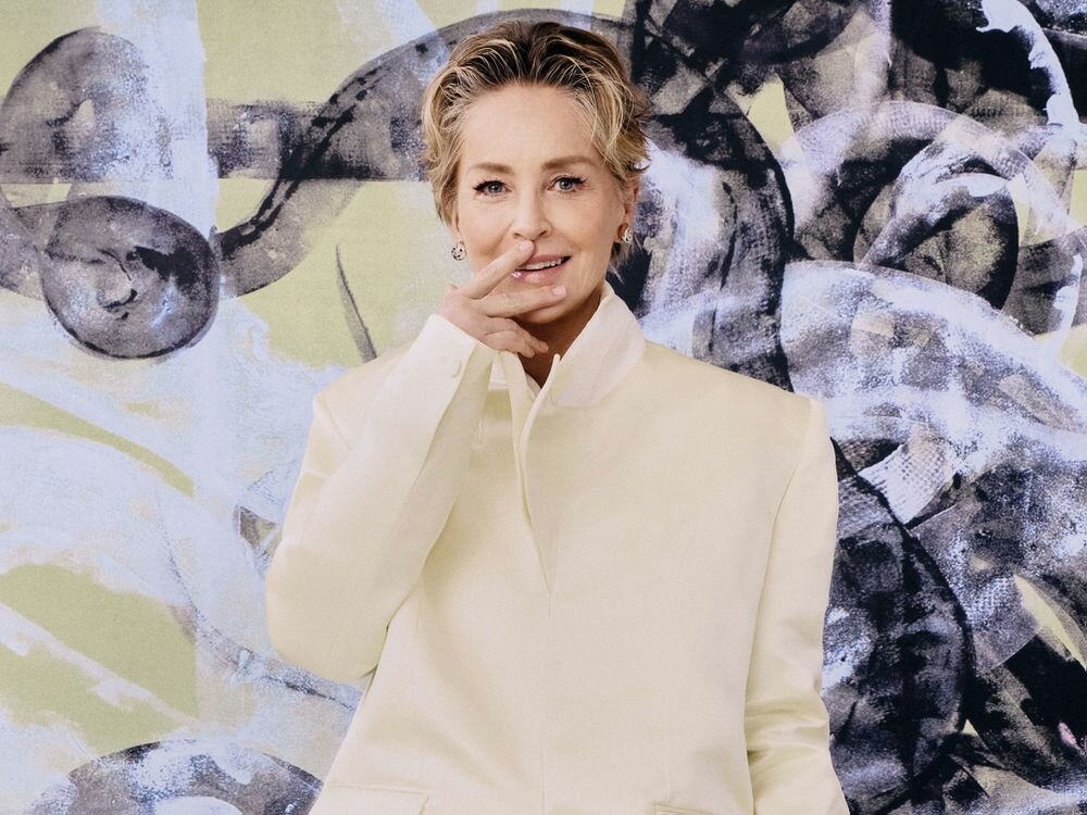 Sharon Stone Yellow Coat Hands Near Mouth