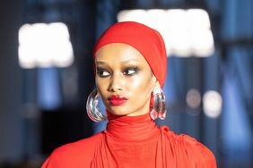 A model at New York Fashion Week wearing large earrings