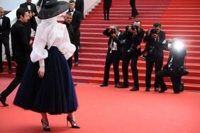 Elle Fanning wearing Dior being photographed on the red carpet of the screening of "Once Upon A Time In Hollywood" during the 72nd annual Cannes Film Festival on May 21, 2019