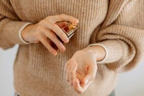 Woman Spraying Perfume On Wrist