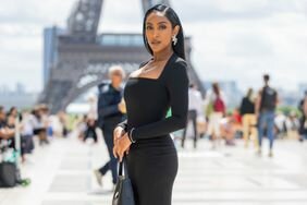 Tayshia Adams in a black dress at PFW