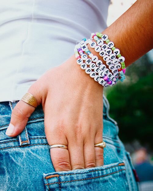 Woman wearing a letter friendship bracelet