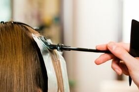 Foilyage _ close-up of person applying hair color to a section of hair