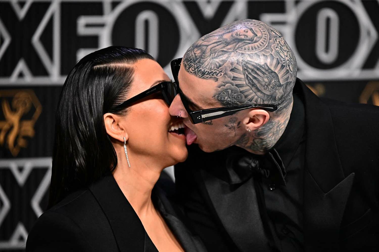 Kourtney Kardashian and Travis Barker kissing at the 2024 emmys