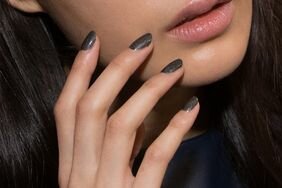 A model poses with JINsoon nails backstage during JINsoon at Vera Wang.