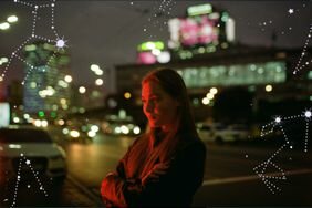 woman at night with arms crossed